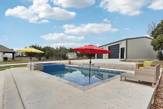 view of swimming pool featuring a patio area and an outbuilding