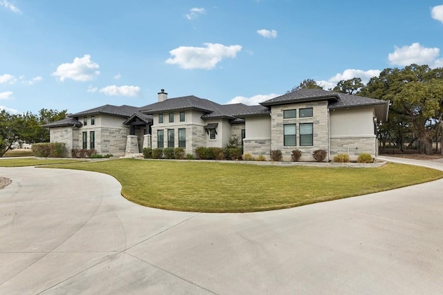 prairie-style home featuring a front lawn