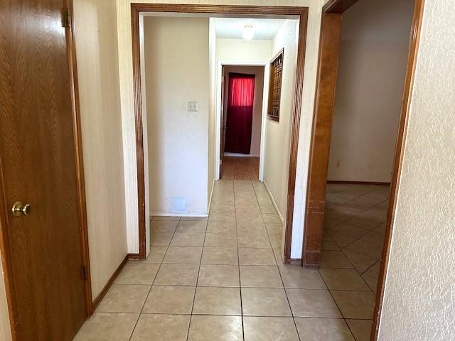 hallway with light tile patterned flooring