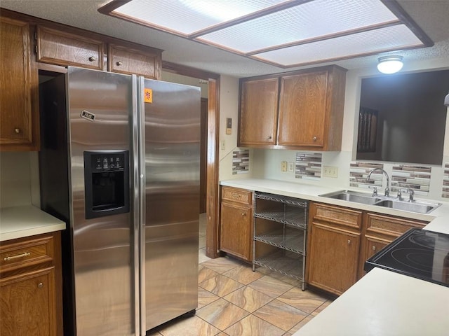 kitchen featuring tasteful backsplash, sink, and black appliances