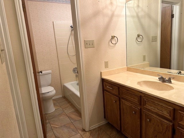 full bathroom with vanity, tile patterned flooring, washtub / shower combination, and toilet