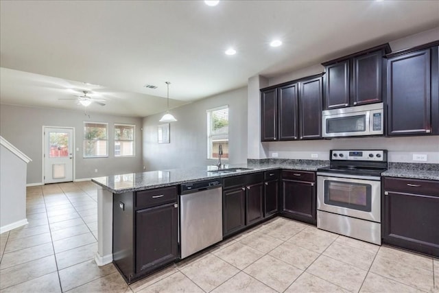 kitchen with ceiling fan, sink, hanging light fixtures, stainless steel appliances, and kitchen peninsula