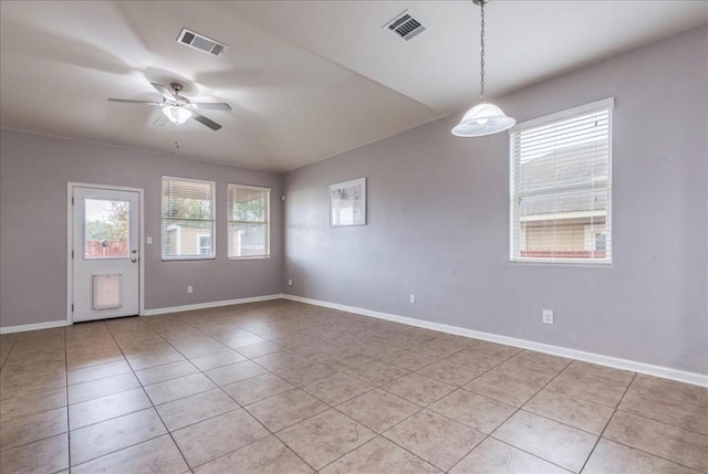 tiled spare room with ceiling fan