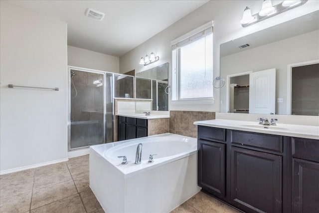 bathroom featuring plus walk in shower, tile patterned flooring, and vanity