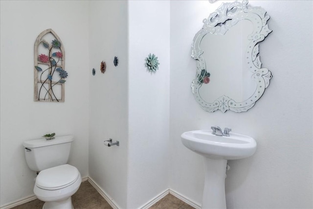 bathroom with tile patterned flooring and toilet