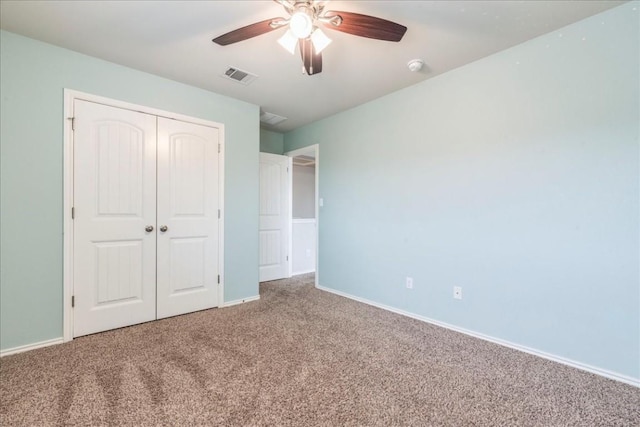 unfurnished bedroom with ceiling fan, a closet, and carpet floors