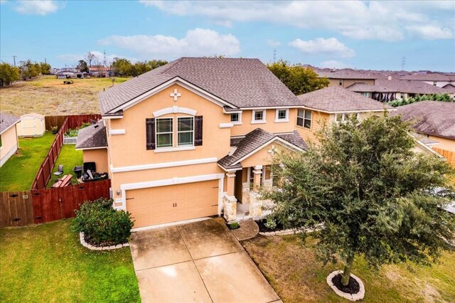 view of front property featuring a garage and a front lawn