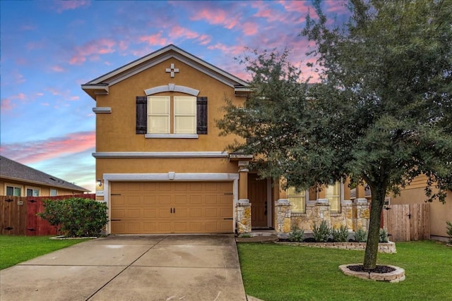 traditional home featuring a garage, stucco siding, fence, a front lawn, and concrete driveway