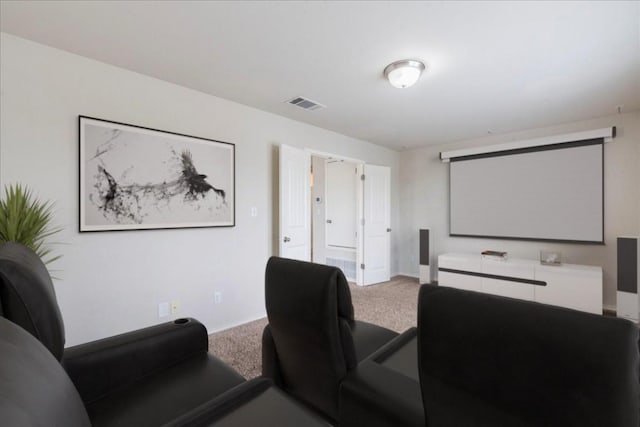 carpeted cinema featuring baseboards and visible vents