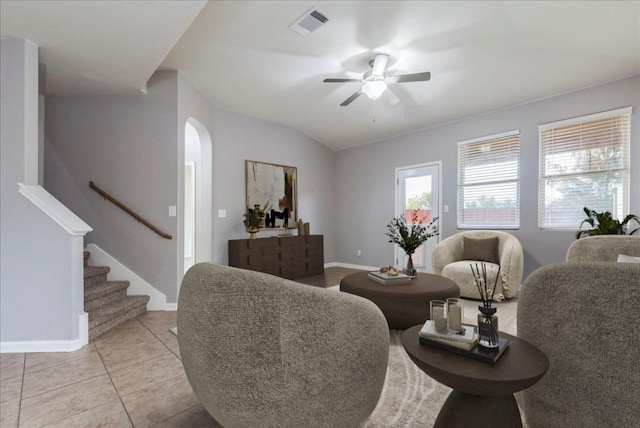 tiled living room with ceiling fan and vaulted ceiling