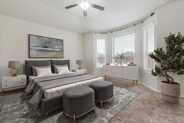 bedroom with ceiling fan, baseboards, and carpet