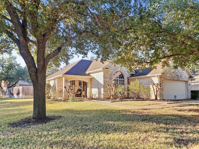 ranch-style home with a garage and a front lawn