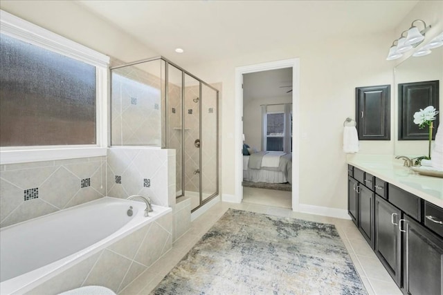 bathroom with plus walk in shower, vanity, and tile patterned flooring