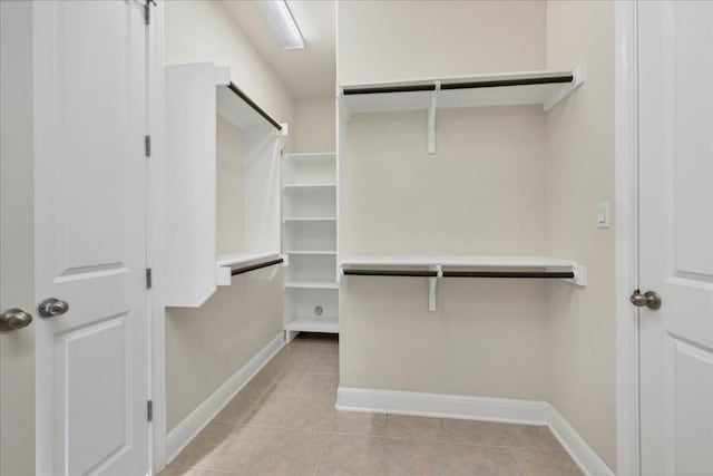 spacious closet with light tile patterned floors