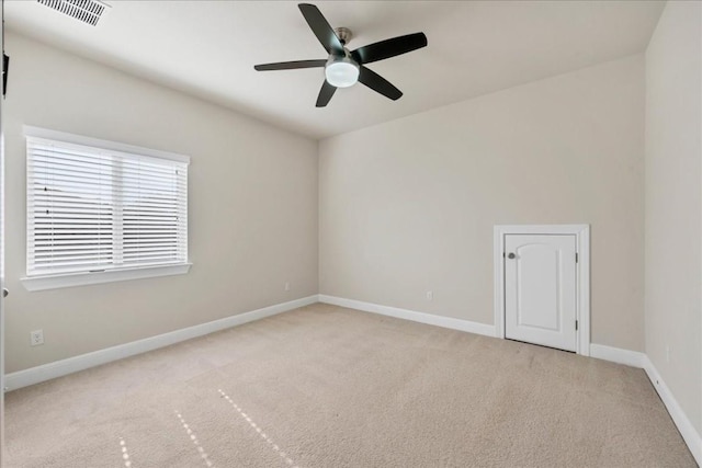 unfurnished room with light colored carpet and ceiling fan