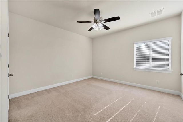 spare room with light carpet and ceiling fan