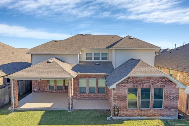 back of house with a patio and a lawn