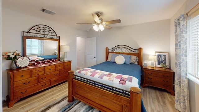 bedroom featuring light wood-type flooring and multiple windows