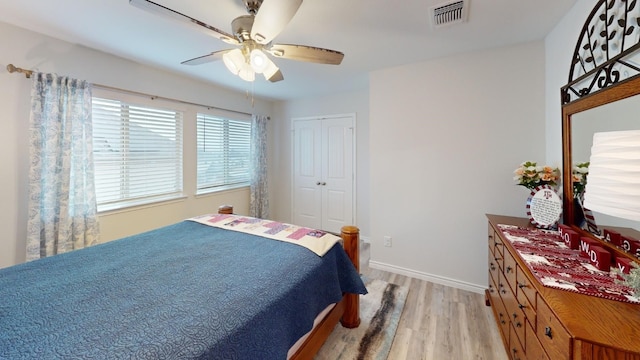 bedroom featuring a closet, light hardwood / wood-style floors, and ceiling fan