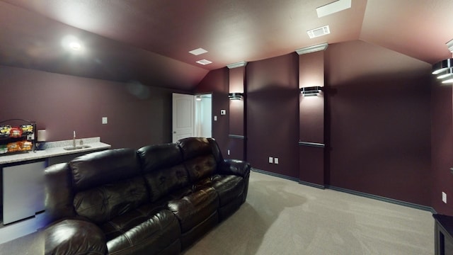 carpeted home theater with lofted ceiling and indoor bar