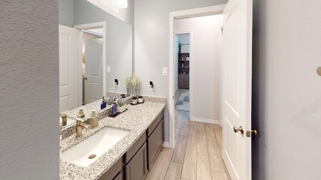 bathroom with vanity and hardwood / wood-style flooring