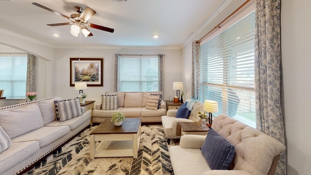 living room with ceiling fan and crown molding