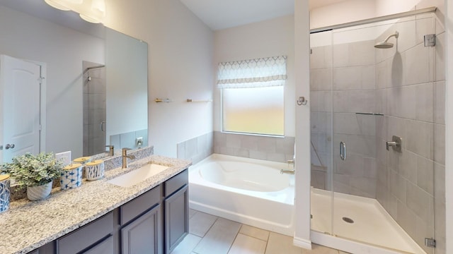 bathroom with shower with separate bathtub, vanity, and tile patterned floors