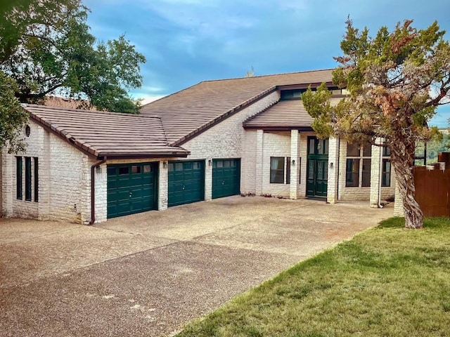 4324 Far W Blvd, Austin, TX 78731 - view of front facade featuring an attached garage, driveway, a tiled roof, and stone siding