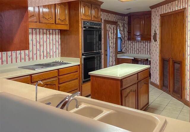 4324 Far W Blvd, Austin, TX 78731 - kitchen with wallpapered walls, stovetop with downdraft, brown cabinetry, light countertops, and light tile patterned flooring