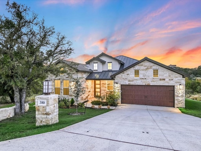 view of front of property featuring a yard and a garage