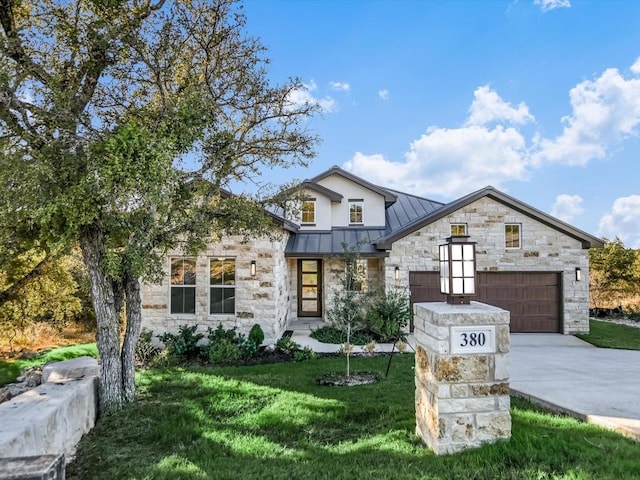 view of front of home with a front lawn and a garage