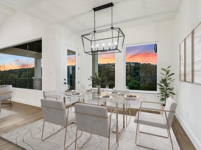 dining area featuring hardwood / wood-style floors and lofted ceiling