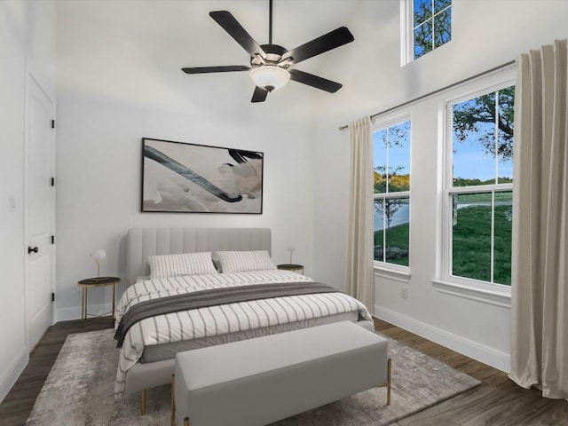 bedroom featuring ceiling fan and dark wood-type flooring