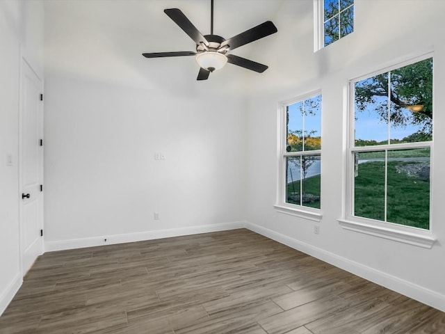 spare room with ceiling fan and dark wood-type flooring