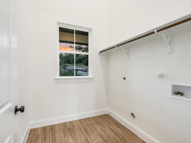 laundry room with hardwood / wood-style floors, hookup for an electric dryer, gas dryer hookup, and hookup for a washing machine