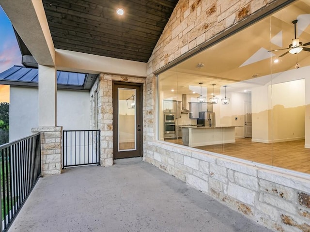 exterior entry at dusk with ceiling fan