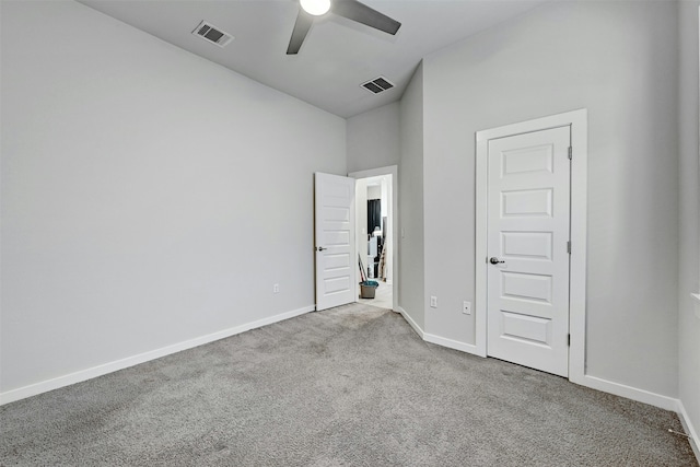 unfurnished bedroom with ceiling fan and light colored carpet