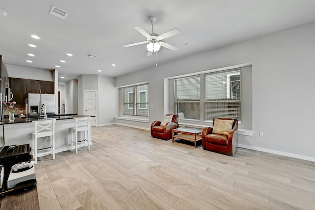 sitting room featuring ceiling fan and light hardwood / wood-style floors