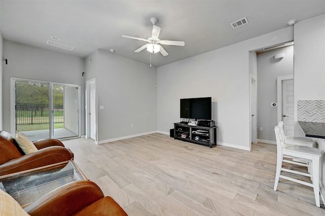 living room with ceiling fan and light hardwood / wood-style flooring