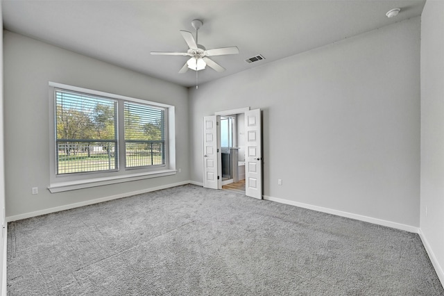 carpeted empty room with ceiling fan