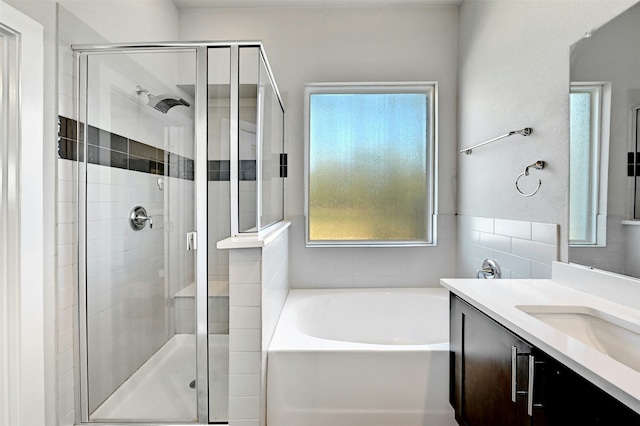 bathroom featuring vanity and separate shower and tub