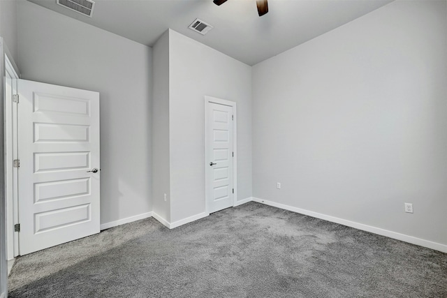 unfurnished bedroom featuring dark colored carpet and ceiling fan