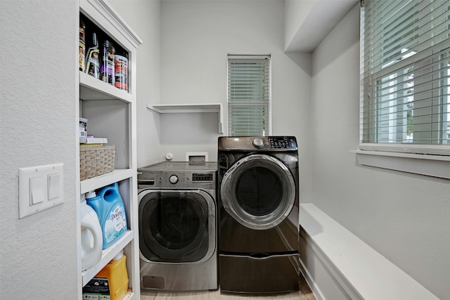 clothes washing area featuring washer and dryer