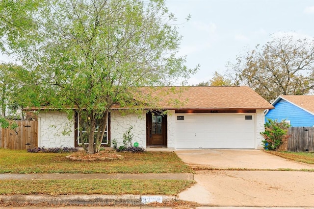 view of front facade featuring a garage and a front lawn