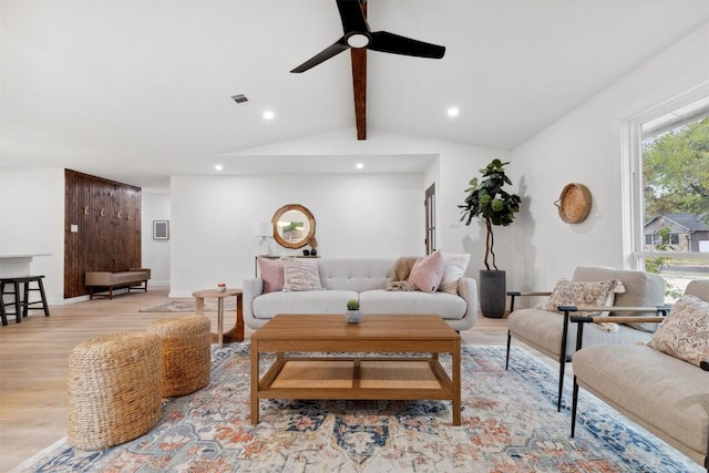 living room featuring vaulted ceiling with beams, ceiling fan, and light hardwood / wood-style floors