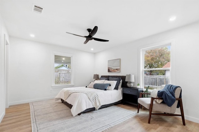 bedroom featuring multiple windows, ceiling fan, and light hardwood / wood-style floors