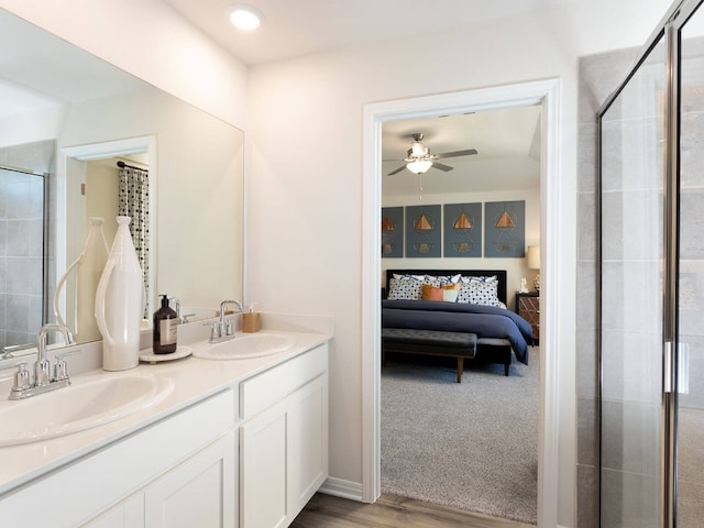 bathroom with vanity, ceiling fan, hardwood / wood-style flooring, and walk in shower