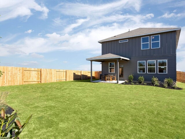 back of property featuring a patio and a lawn