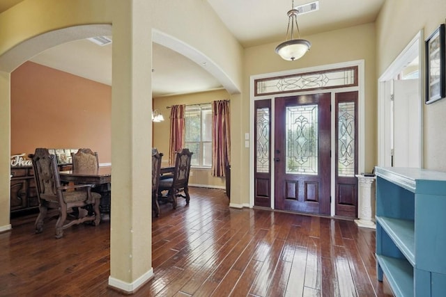 entrance foyer featuring dark hardwood / wood-style floors and an inviting chandelier