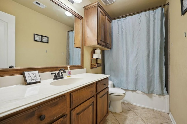 full bathroom featuring tile patterned floors, vanity, shower / bath combination with curtain, and toilet